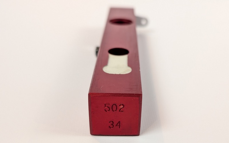 MEC charge bar end showing stamped markings 502 and 34